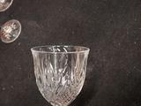 a glass that is sitting on a table next to a wall