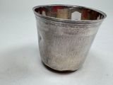 a silver cup that is sitting on a table