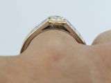 a close up of a person ' s hand holding a diamond ring
