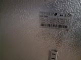 a close up of a metal door with a barcode on it