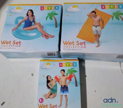 three boxes of wet set on a table with a woman in a bathing suit and a man in a bathing suit