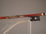a close up of a bow with a stick attached to it
