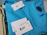 a blue shirt with a price tag on it next to a pair of pants
