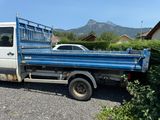 a blue truck that is parked in a parking lot