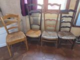 four wooden chairs in a row in a room