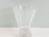 a clear glass vase sitting on a white table