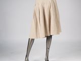 mannequin dressed in a beige skirt and black top with black shoes