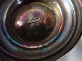 a close up of a silver vase with a logo on it