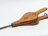 a wooden instrument that is sitting on a white surface