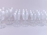 a lot of wine glasses that are lined up together