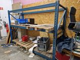 a work area with a shelf and a chair in it