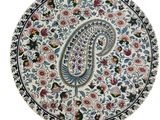 a close up of a plate with a paisley design on it