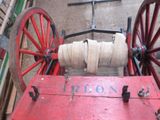 a red wagon with a white rope on top of it