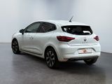 the rear end of a white car parked in a white room