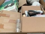 a cardboard box full of items that are sitting on the ground