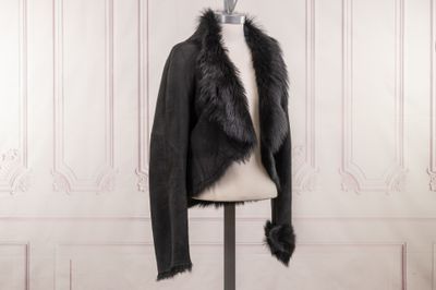 a black jacket with a fur collar on a mannequin mannequin