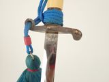 a blue tassel hanging from the handle of a sword