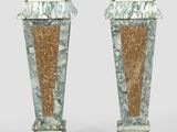 pair of green and brown marble pedestals on a white background