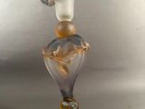 a picture of a glass vase on a stand on a table