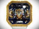 a blue and gold plate with an elephant on it