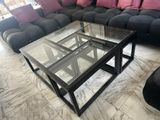 a coffee table with a glass top in a living room