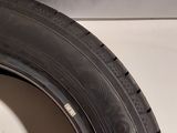 a close up of a tire on the side of a white wall