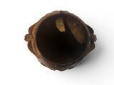 a brown vase with a hole in it on a white surface