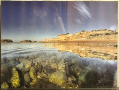 une photo d'une photo représentant une plage avec des rochers dans l'eau