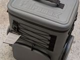 a gray suitcase with a handle and a tag on it