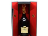 the bottle of champagne is in the open box on the table