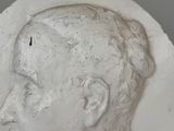 a close up of a plaster of a man ' s head
