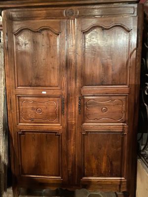 a large wooden armoire with two doors on each side