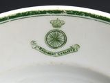 a green and white plate with a crown on it