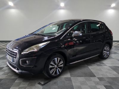 the black car is parked on a checkered floor in the garage