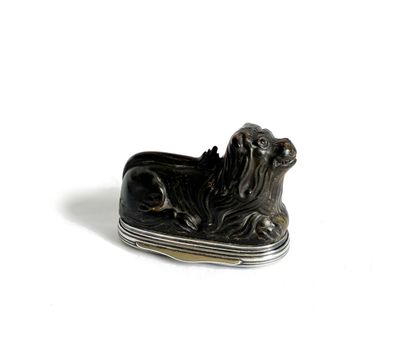 a picture of a black and silver dog figurine on a white surface