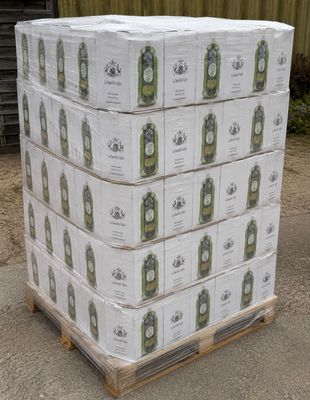 boxes of beer stacked on a pallet in front of a building