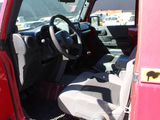 a red car with a black steering wheel and a black seat