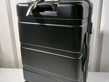 a black suitcase sitting on top of a white table