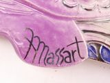 a purple bird with a name on it sitting on a table