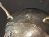 a silver object with a skull on top of it