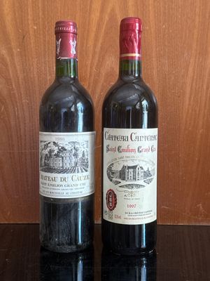 two bottles of wine sitting next to each other on a table