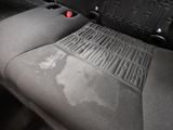 a dirty seat in the back of a car