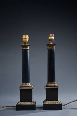 a pair of black and gold table lamps