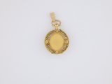a gold pendant with a yellow stone in the center