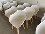 many white chairs lined up in a row on the floor