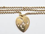 a necklace with a heart shaped pendant on a chain