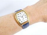a woman ' s wrist that has a watch on it