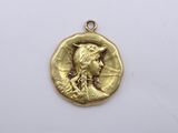 a close up of a gold coin with a woman ' s face on it
