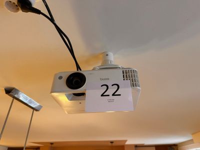 a video projector hanging from the ceiling with a price tag attached to it