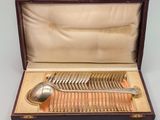 silver plated fishbone spoon and spoon rest in a wooden box